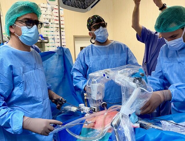 Surgeon and surgical team performing robot assisted laparoscopic surgery in Portugal